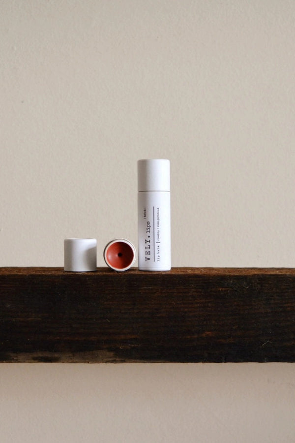 Three cylindrical containers on a wooden surface with a neutral background